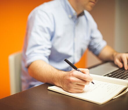 Business man writing on desk